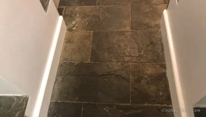 Heavy soiling across slate tiles and grout lines before cleaning