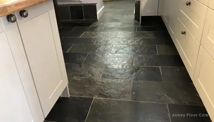 Restored green black slate floor with clean grout and even sheen